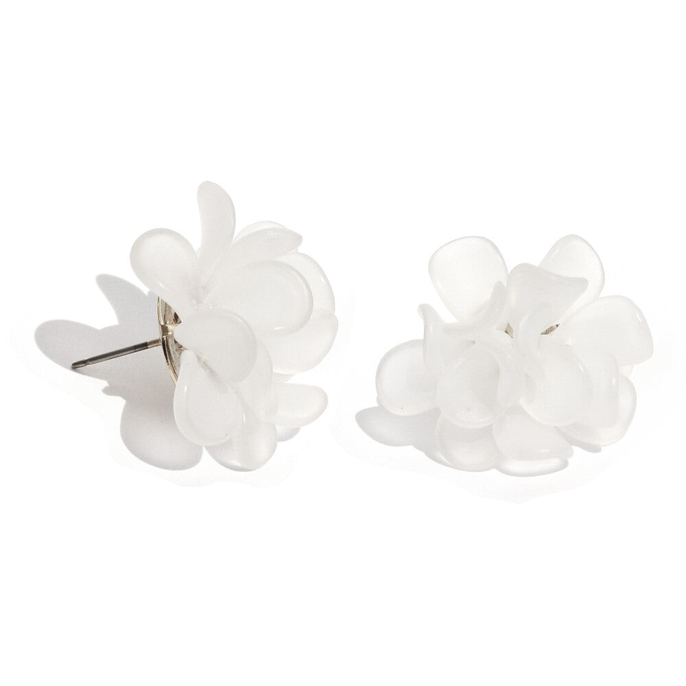 A pair of white faux-flower stud earrings on a clean white background, with one earring shown from the side to reveal the metal post.