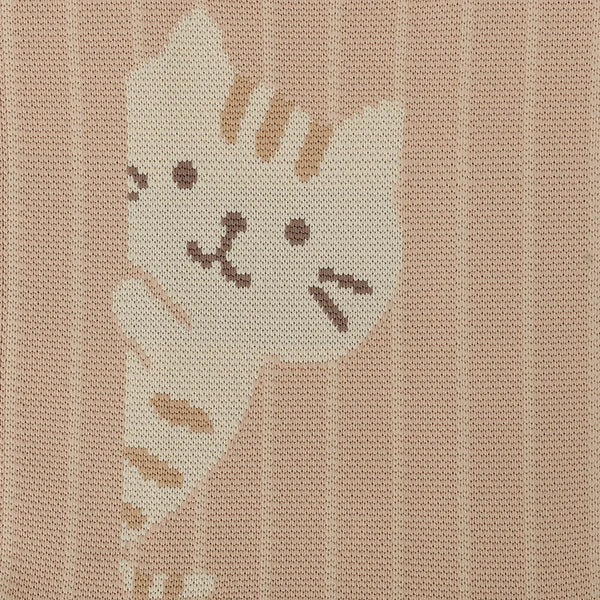 A close-up of a woven textile featuring a cream-colored tabby cat illustration on a warm beige background with vertical stripes.