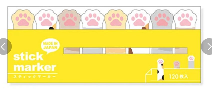 A yellow pack of cat-themed sticky markers with paw print illustrations along the top and Japanese text including 'stick marker' and '120 枚入'.