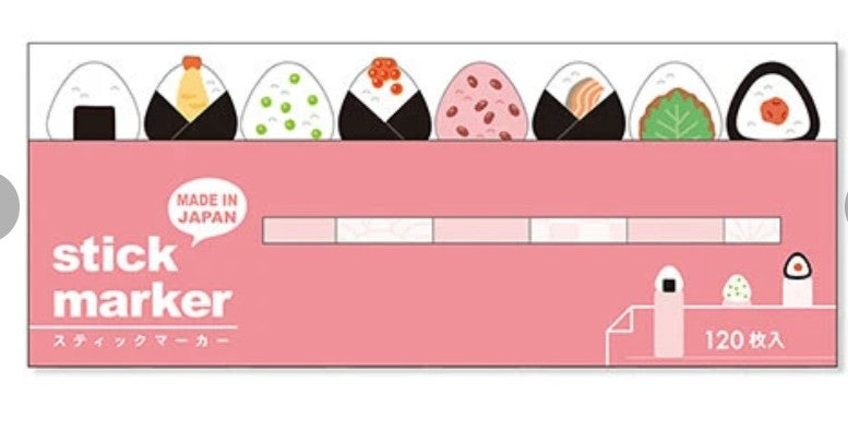 A pink stick marker package labeled 'stick marker' with 'MADE IN JAPAN' and '120 枚入'. The top shows illustrated onigiri, and the marker slots are printed across the center.