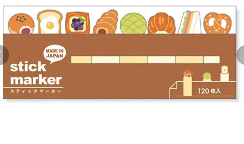 A pack of 120 stick markers featuring a cute bakery-themed design. The packaging is brown with illustrations of various pastries, breads, and sandwiches along the top, and white text reading 'stick marker' and 'MADE IN JAPAN'.