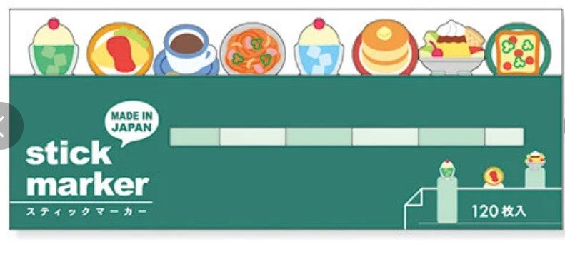 A package of 120 stick markers in a dark green box with colorful illustrations of various food items along the top. The text 'stick marker' is printed in white, alongside a 'MADE IN JAPAN' badge and '120 枚入' indicating the quantity.