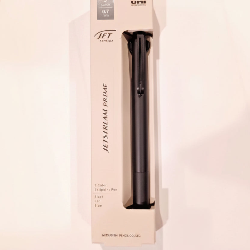 Mitsubishi Pencil JetStream 0.7mm ballpoint pen in its original beige packaging box, featuring a black pen with red and blue color accents.