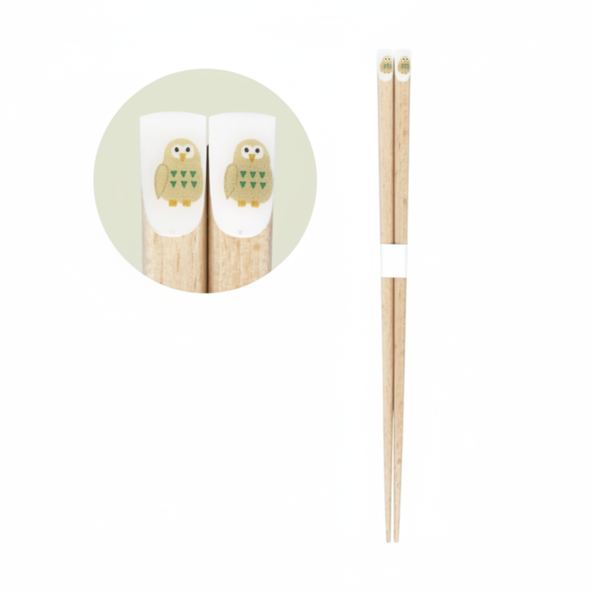 Light wood chopsticks with a small owl illustration near the top, shown on a white background with a circular inset detail and Japanese text reading 'carve' and '22.5cm'.